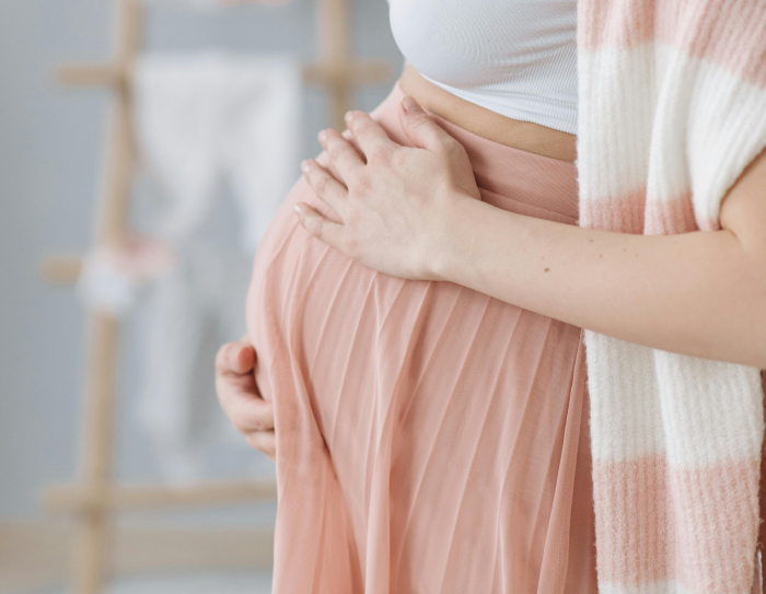 Pregnant mother holding belly