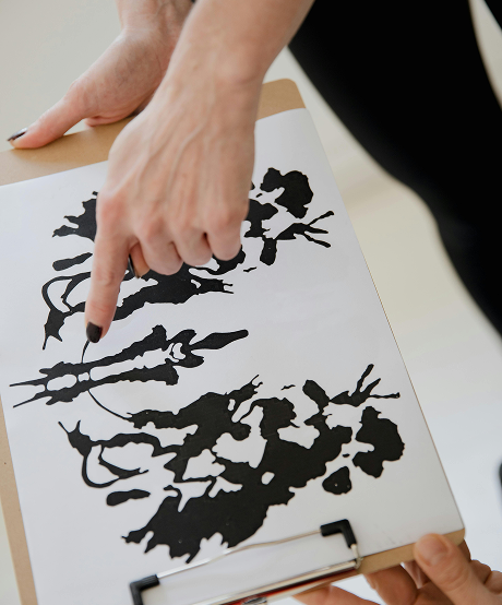 Therapist pointing at paint splotch image