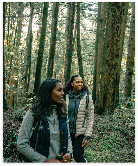 Two friends hiking through the woods