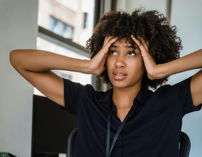 Women looking stressed with hands on forehead
