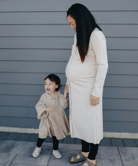 Young mother holding childs hand